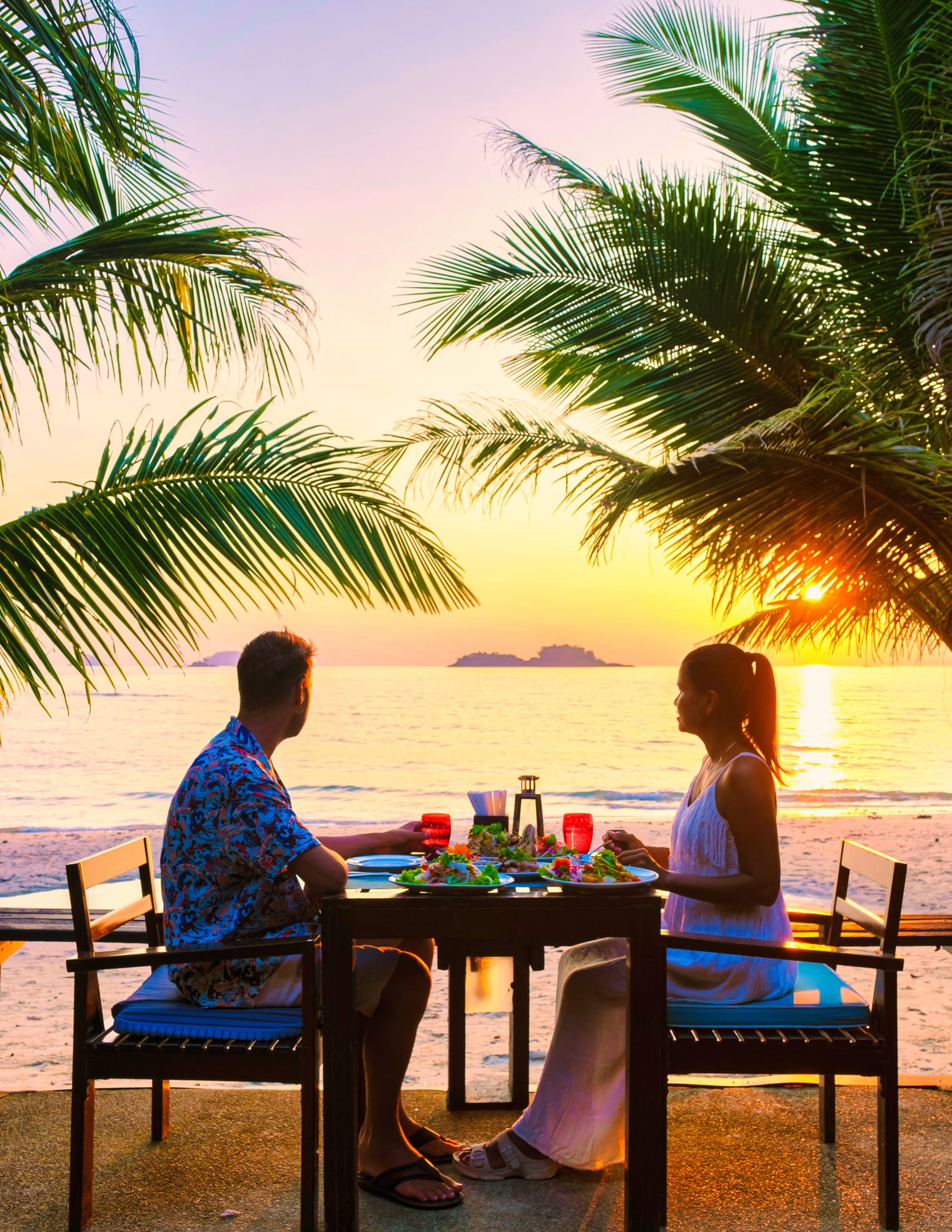 Couple having a romantic dinner on the beach in Grand Case, St. Martin.